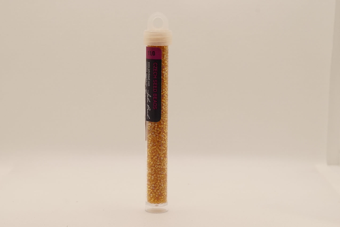66- 11/0 Vial Transparent Topaz AB